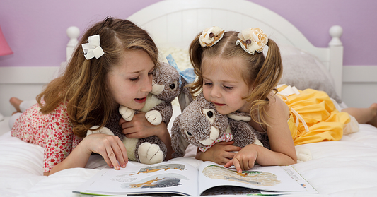 Sisters read a new book with the bunnies they crafted themselves.