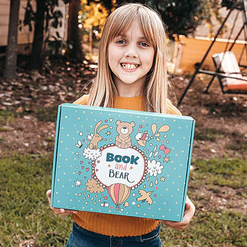 Eight year old girl with a Book and Bear Box