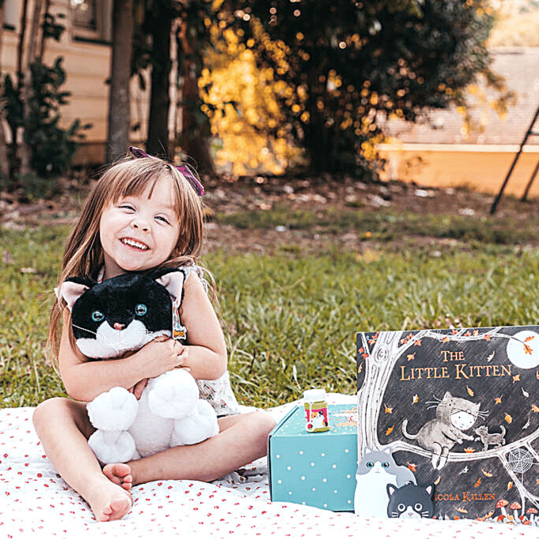 Girl hugs the kitten she crafted with her Book and Bear Kitten Crafting and Book Set